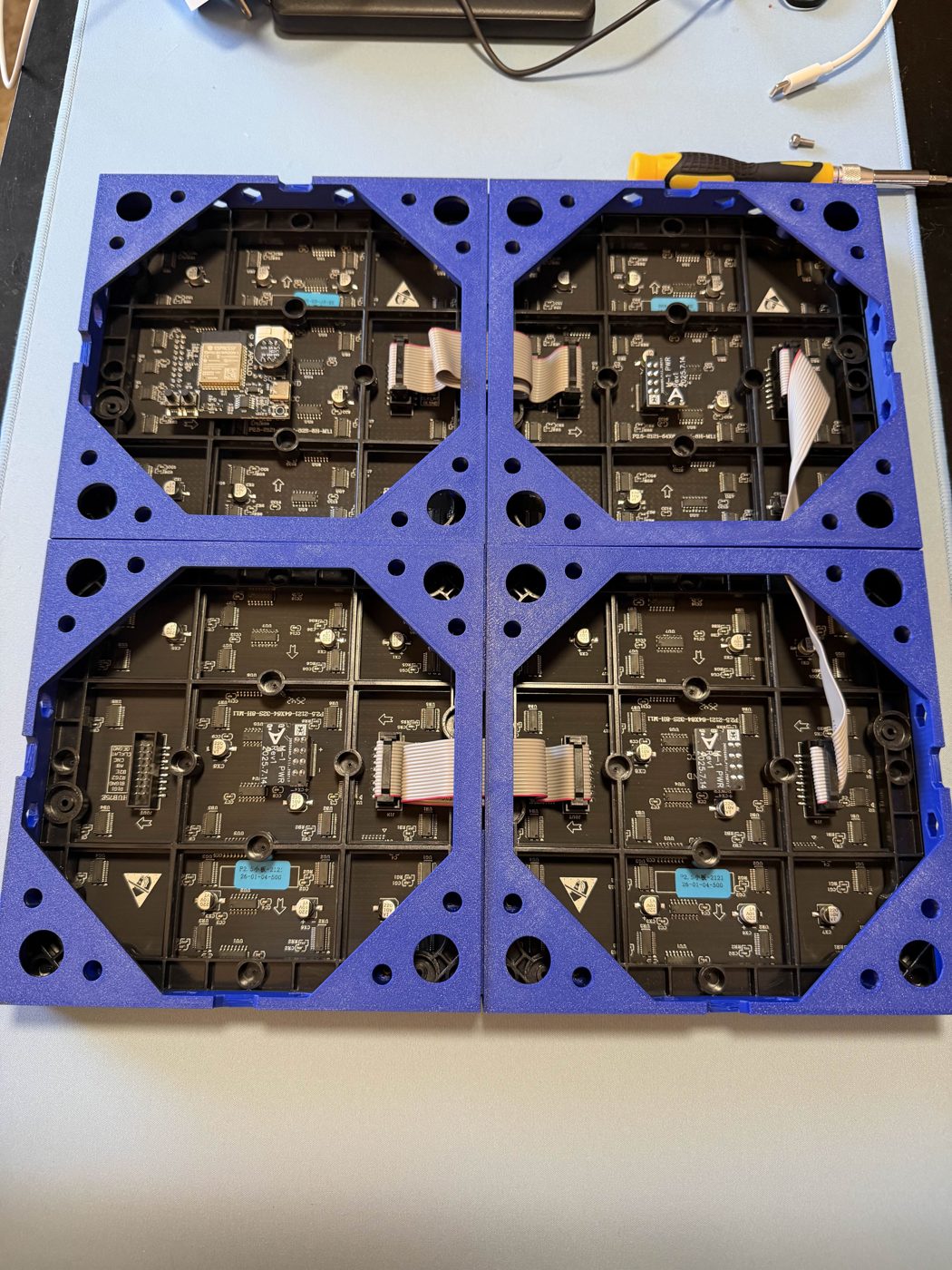Rear of a 2 x 2 matrix of four 64 x 64 panels. The bottom row is mounted rotated 180° so the ribbon cables reach between the rows.